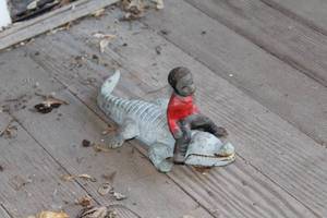 lot 214A image: Boy Riding Alligator Cast Iron Sculpture