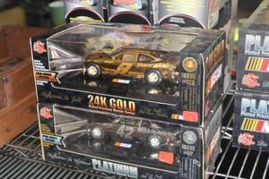 lot 79 image: Lot of (2) Diecast 24K Gold #9 Issue #12G, Platinum #42 Issue #9P NASCAR Car Replica (in original packaging)