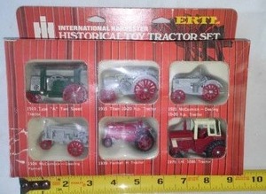 lot 52 image: ERTL Historical International Harvester Toy Tractor Set.