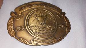 lot 74 image: N.D. Centennial Belt Buckle