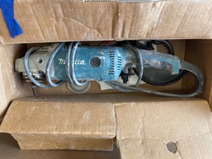 Makita 15 Amp 7 in. Corded Angle Grinder with Grinding wheel, Side handle and Wheel Guard Used