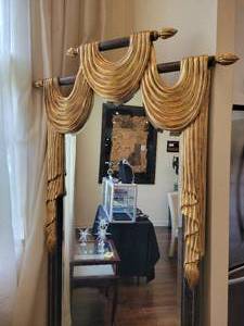 lot 3 image: Large 7 Foot Gold and Wood Framed Drape and Rod Beveled Mirror.