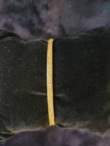 lot 40 image: 14K Yellow Gold Hinged Bangle Bracelet with Diamond Pattern. 5.3 grams.