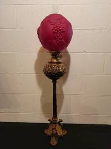 lot 61 image: Dragon  Griffin Lamp with Embossed Grapes & Leaves Cranberry Satin Shade. Duplex Burner.