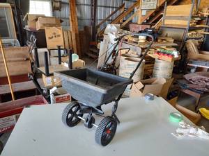 lot 56 image: Red devil grass seed spreader