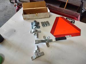 lot 77 image: Door latch replacement kit and slow moving sign