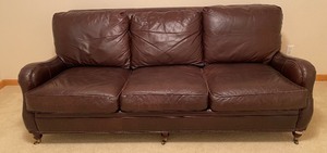 lot 74 image: Classy Leather Sofa with Rivet Detailing on Casters