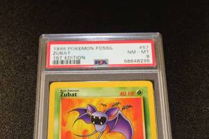 lot 13 image: 1999 Pokemon Fossil 1st Edition Zubat #57 PSA 8