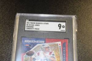 lot 186 image: 2021 Rookies & Stars Airborne Longevity Prizm Mac Jones #AB-20 Rookie Card SGC 9