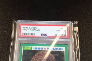 lot 241 image: 1989 Score Troy Aikman #270 Rookie Card PSA 8