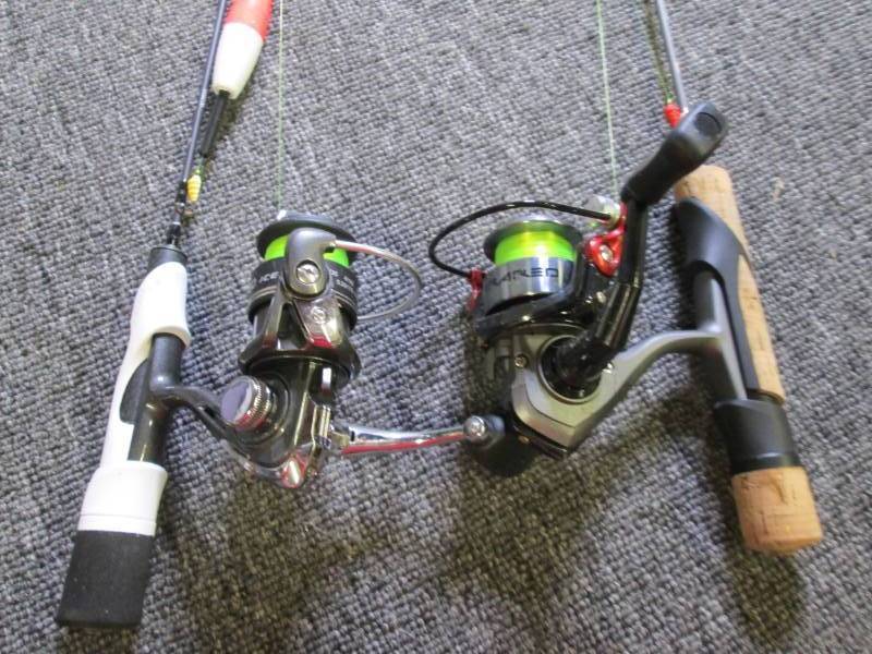 2 ice fishing rods white handle one...