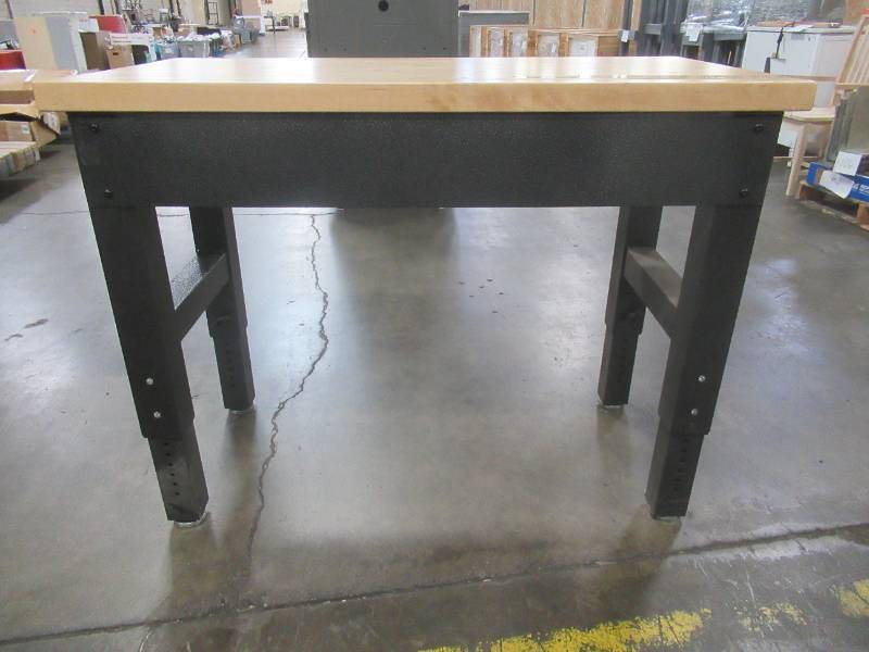 lot 260 image: Gladiator Work Bench, Approximate Dimensions 48 x 25 x (Height Adjustable, stands at 36 in photo). - Used in warehouse.