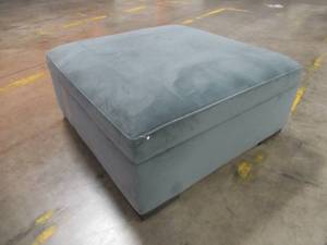 lot 438 image: CREATED FOR MACYs RADLEY FURNITURE  Storage Ottoman in Heavenly Naval On Casters. In Like New Condition. Approximate Dimensions 36 x 36 x 16 Tall.