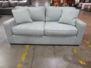 lot 443 image: CREATED FOR MACYs RADLEY FURNITURE Condo Sofa in Zuri Mist. In Like New Condition. Approximate Dimensions 74 x 38 x 30 Tall.