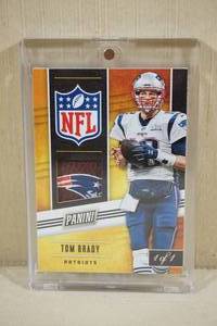 lot 27 image: 2019 Panini Tom Brady Card with Piece of Game Used Football - 1 of 1