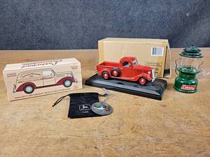 lot 1189 image: Fairfield Mint 1937 Ford Pickup Diecast Model, 1937 Chevrolet Sedan Delivery Diecast Model, 1999 John Deere Ornament and Mini Coleman Lantern