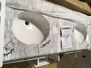 lot 29 image: Home Decorators Collection Windlowe 61 in. W x 22 in. D x 35 in. H Bath Vanity in White with Carrera Marble Vanity Top in White with White Sink Broken Granite and Door Damaged Se Picture Customer Returns See Terms on  Auction