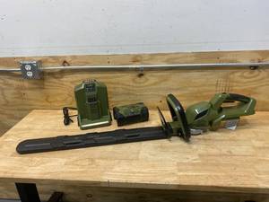 lot 41 image: GREEN MACHINE 62V Brushless 25in. Cordless Battery Push start Hedge Trimmer with Rotating Handle and 2.5 Ah Batter and Rapid Charger