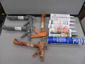 7 CONTAINERS OF CAULK AND 4 CAULK GUNS