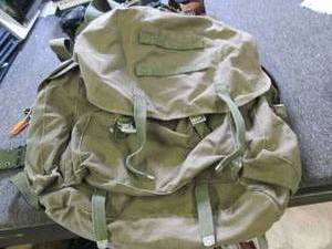 green bag with gun holsters and bel...