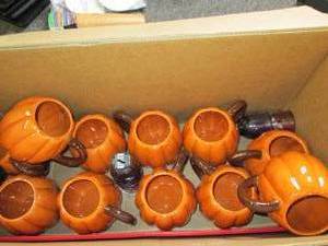 box of halloween pumpkin mugs and m...