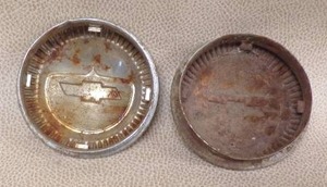 lot 28 image: Chevy (broken) car emblem (2 covers)