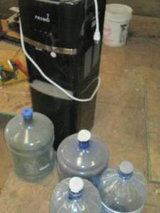 Primo water cooler with 4 water jug...