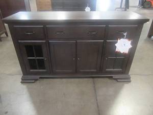 lot 129 image: CREATED FOR MACYs LEGACY CLASSIC FURNITURE Solid Wood Buffet 4 Doors (The 2 Side Glass Doors Have internal Lighting), Adjustable Shelves, 3 Drawers With Velvet Inlays. Approximate Dimensions 62 x 19 x 36 Tall.