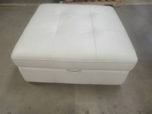 lot 158 image: CREATED FOR MACYs MOTOMOTION FURNITURE, Leather Ottoman With Storage on Casters in White. Approximate Dimensions 40 x 40 x 18 Tall.