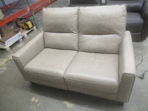 lot 172 image: CREATED FOR MACYs VIOLINO FURNITURE, Leather Power Reclining Loveseat in Tan. Approximate Dimensions 58 x 35 x 35 Tall.