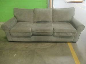 lot 202 image: CREATED FOR MACYs TIMBERLAND FURNITURE, Sofa in GrayOlive. Zippers Broken On Bottom Cushions, Noticed HairChewing....Dog (See Photos). Approximate Dimensions 63 X 36 X 30 Tall. USEDRETURN.