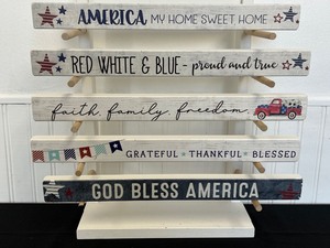 Variety of American Pride Wall Hangings and Wooden Display Stand