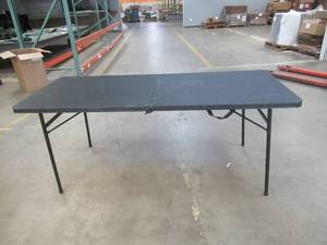 lot 739 image: 96 IN W X 30 IN D X 29.2 IN H BLACK FOLDABLE PLASTIC TABLE (TABLE TOP SLIGHTLY DAMAGED, SEE PHOTOS)