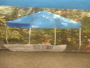 lot 750 image: OZARK TRAIL 10 x 10 Instant Slant Leg Canopy - Blue Top.