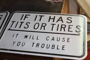 lot 613A image: It It Has Tits Or Tires It Will Cause You Trouble Metal Sign