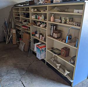 Contents of (23) Shelves - Misc. Housewares, Curtain Rods and More - Includes headboard on Wall - Shelves NOT Included