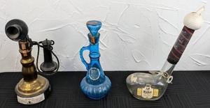lot 62 image: (3) Vintage Novelty Whiskey Bottles Beam 100 Months Old In Replica Phone, Beam 8 Yrs. Old in Blue Glass Decanter, George Dickel Whiskey in Glass Golf Club