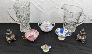 lot 75 image: Beautiful Kitchen Items (2) Glass Crystal Pitchers, Pair of Silver Salt & Pepper Shakers, (2) Teacups, Sugar bowl with Lid, & Small Decorative Floral Piece
