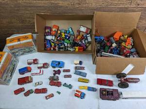 lot 326 image: (2) Vintage Metal Pit Stop Car Carrying Cases and (2) Boxes of Vintage Toy CarsTrucks, Fisher Price Pull Train, Hot Wheels