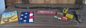 lot 206 image: Weaponry Arrowhead Throwing Knife, Bear Glass-Powered Grizzly Bow, Ammunition, US Flag, 1959 Gun Digest, and Leather Holster