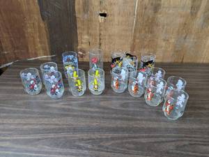 lot 256 image: A Collection of Vintage Glasses Including Miss Piggy, The Rice Krispie Elves, Holly Hobbie, Tony the Tiger, Schoolhouse Rock, McDonalds Hamburgler