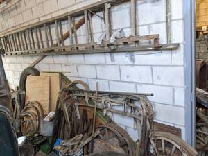 lot 395 image: 18 Foot Ladder and Parts of a Disassembled Antique Buggy, Wagon Wheels, Scrap Metal, Wood and More