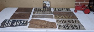 lot 397 image: Collection of Vintage MN License Plates, Other Metal Signs, & a Red Wooden Toy Farmall Tractor