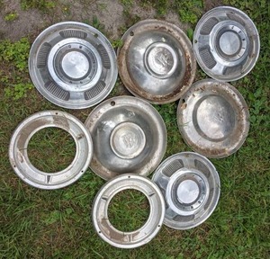 lot 26 image: Collection of (8) Vintage Hubcaps from Comet, Plymouth, and More