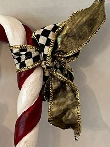 lot 53 image: Mackenzie Childs Nutcracker Ornament and Bonus Candy Cane Ornament with Courtly Check Ribbon