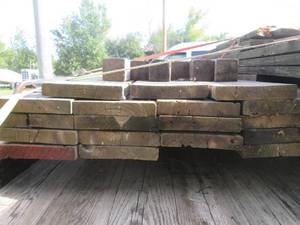 lot 001 image: Lumber 18 - 2 x 10 x 12 ft Green Treated and 6 - 4 x 4 x 8 ft Posts In Good Used Condition  - Does Have Some Screw Holes