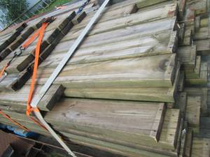 lot 002 image: Lumber Approx 80 - 2 x 6 Green Treated Majority are 12 Feet Long - In Good Used Condition - Does Have Some Screw Holes