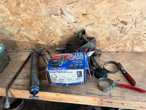 lot 55 image: Tire Chains, Oil Filter Wrenches & Grease Gun