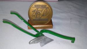lot 357 image: John Deere Belt Buckle Single Bottom Plow And ND Centennial Plow