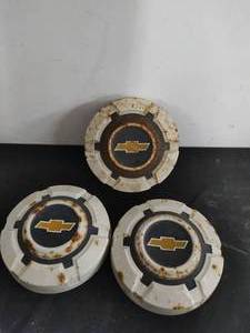 Three Chevy Hubcaps